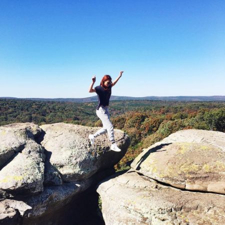 Taylor Patterson is jumping from one rock to another.